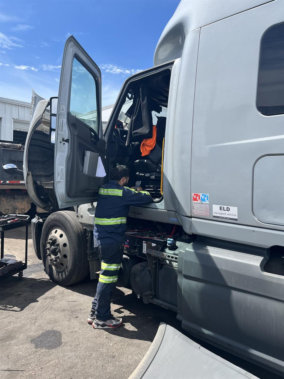 Technician checking truck cab electrical and diagnostics