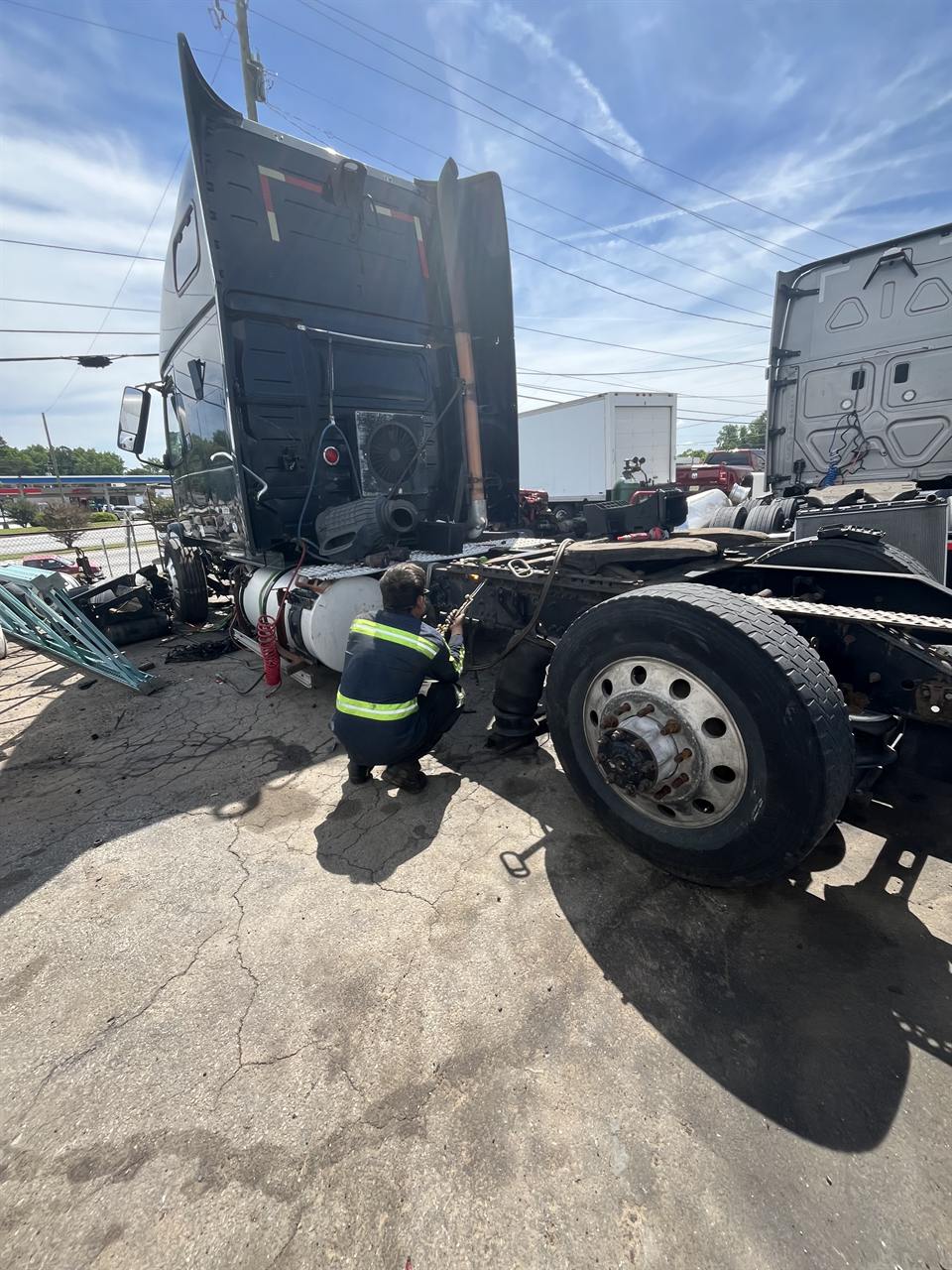 Mobile diesel technician repairing a semi truck on-site in Conley, GA