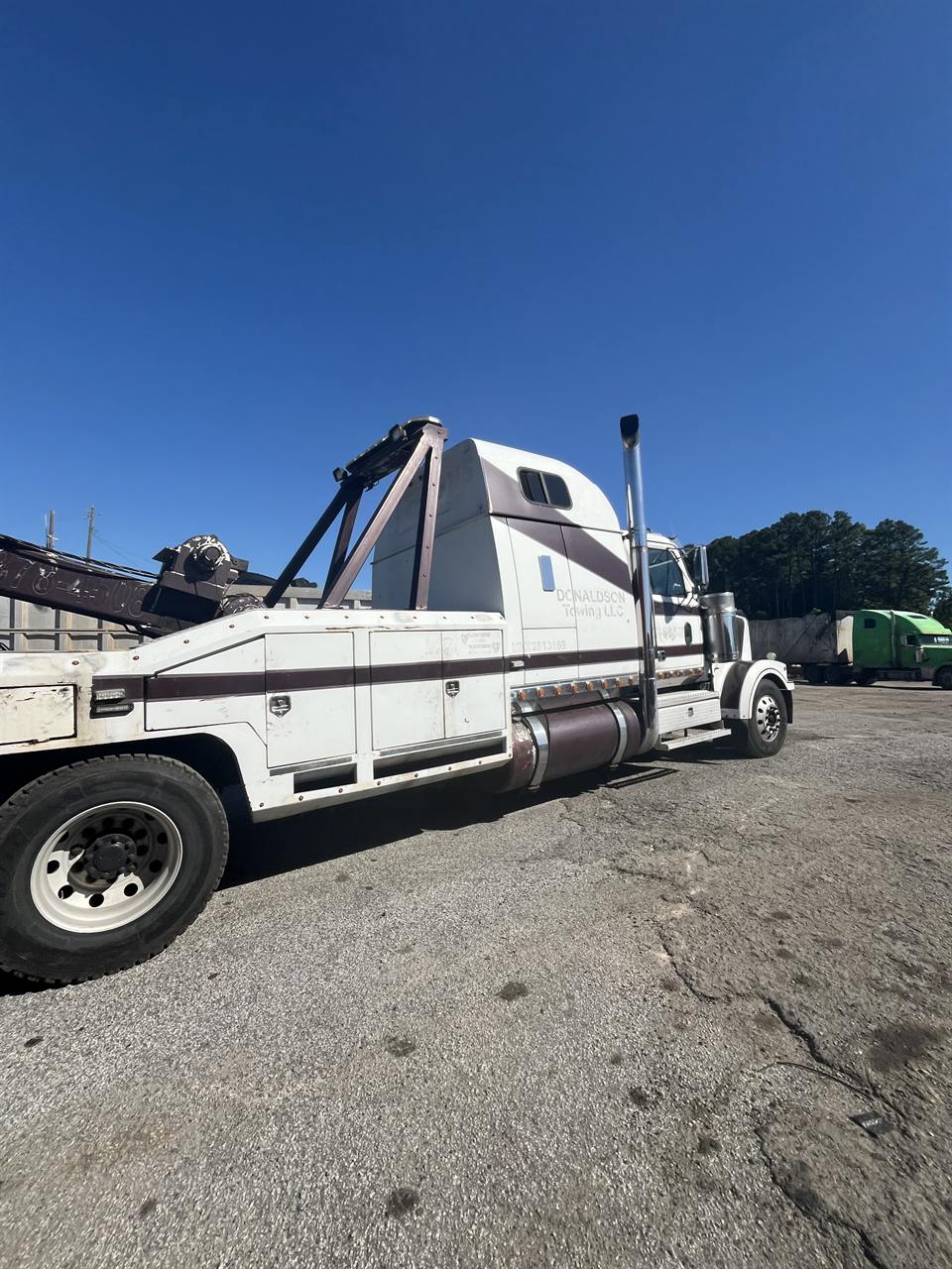 Heavy-duty tow truck ready to recover a semi in Conley, GA